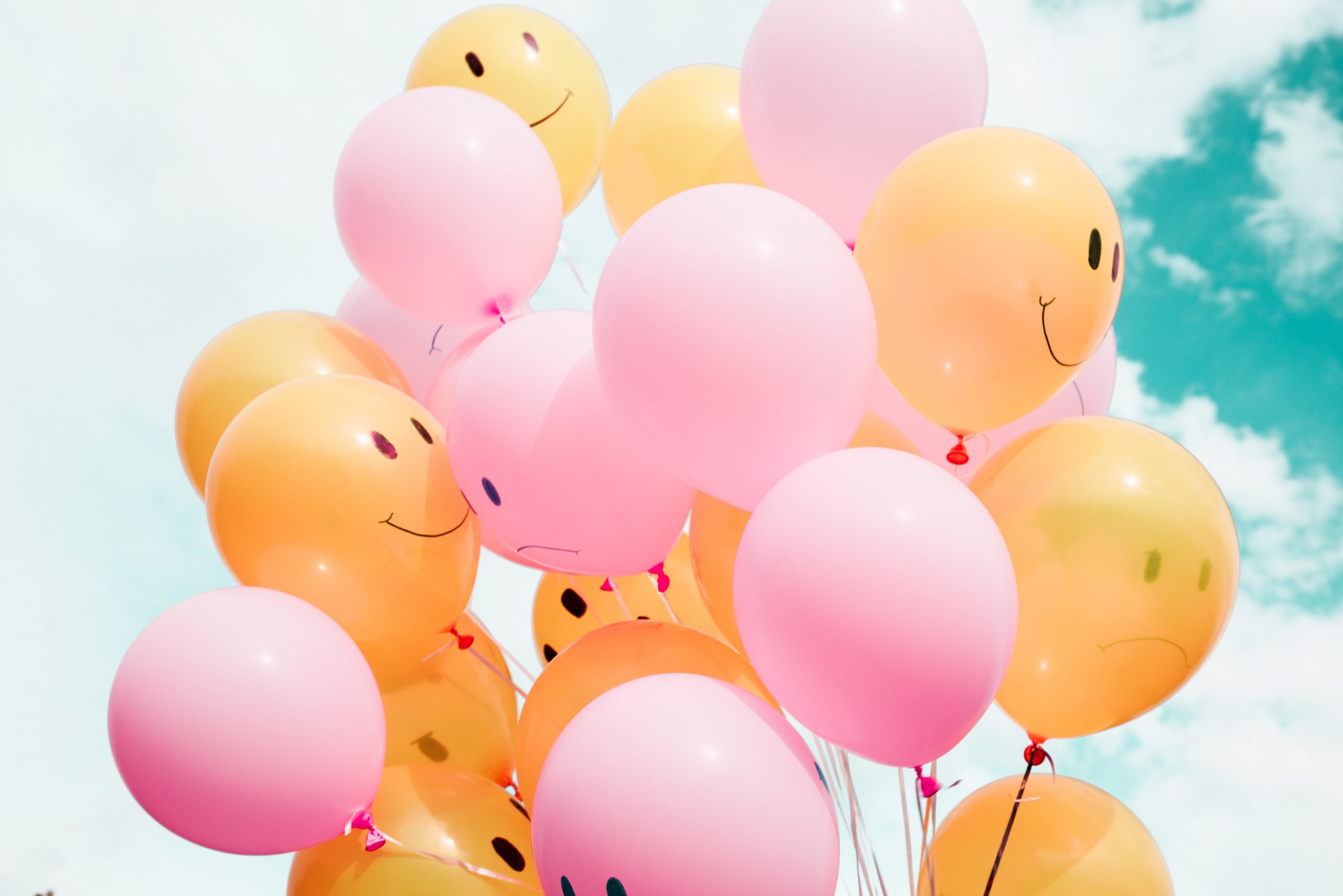 Picture of smiling and frowning balloons in the air, celebrating the many Melbourne school holidays activities happening around the city