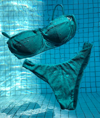 A Brazil Born bikini in an aqua colour floating on the surface of a pool