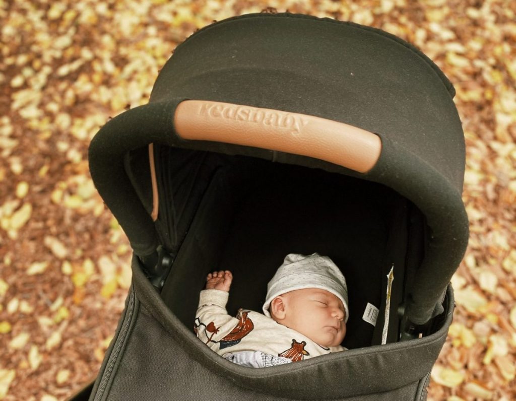 Picture of a sleeping baby in a Redsbaby Metro 3 pram, showcasing why the Redsbaby pram reviews favour this new model