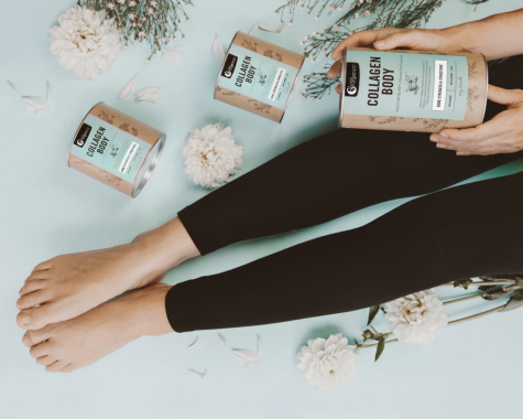 Picture of the Nutra Organics collagen powder in a tin, being held by a woman in yoga leggings