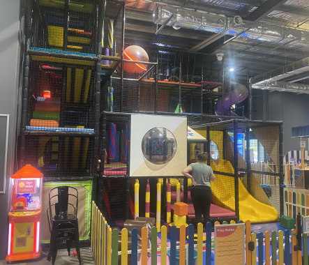 Picture of the Playzone area at Go Climb Coburg, with a parent standing watching their child