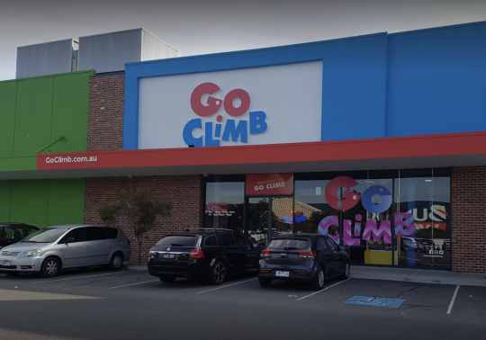 Picture of the Go Climb Coburg entrance, with cars parked in front of the indoor playcentre in Melbourne