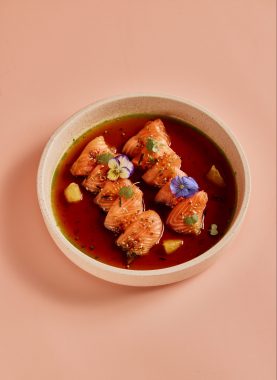 Picture of raw salon in a soy broth and a blush pink background, at Grand Lafayette Prahran