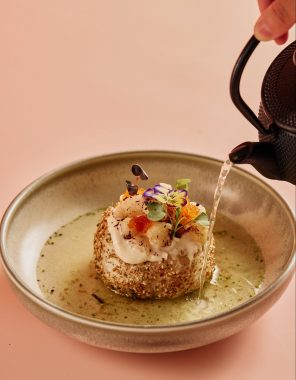 Picture of a small Japanese dish which has a pot of tea being poured into the bowl at the Grand Lafayette Prahran restaurant