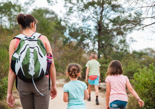 Picture of a mother and three children enjoying some outdoor activities in Melbourne with kids as they follow a trail