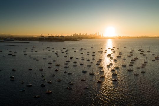 Picture of Williamstown Beach, the ideal place for outdoor activities in Melbourne, with boats on the water and a sunset