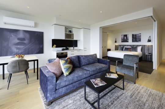 Picture of R Hotel Geelong, showing a spacious one bedroom apartment Geelong accommodation with Rone artwork and modern furniture