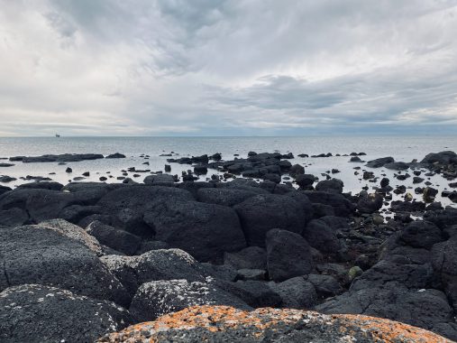 Picture of the black rocks that sit to the side of Williamstown Beach Victoria