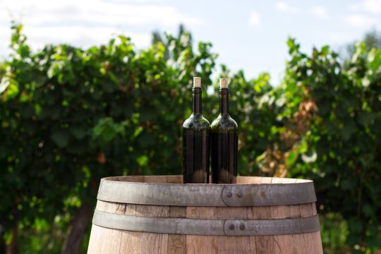 Picture of two wine bottles on a wine barrell at St Anne's Winery in Werribee Gorge