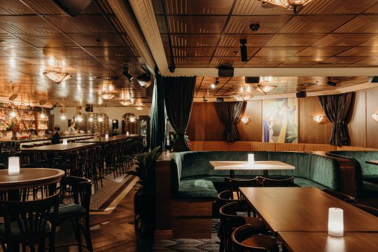 Picture of the Nick & Nora Melbourne bar, with the 1930s aesthic and dim lighting creating a soft glow in this low-ceiling bar