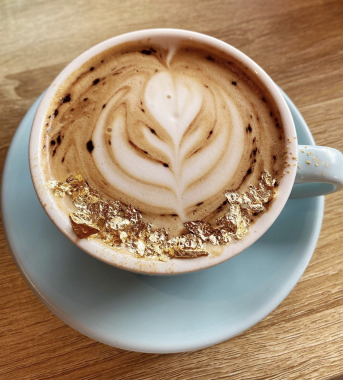 Picture of a latte with gold flecks on top at Feekah cafe Moonee Ponds