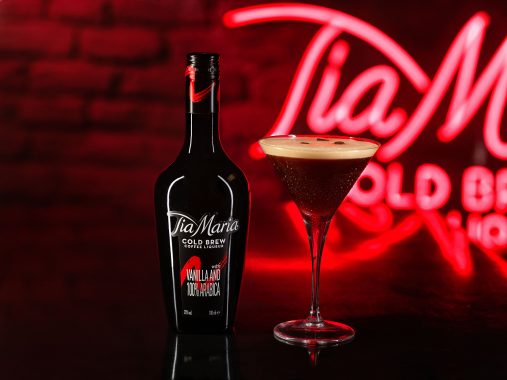 Picture of the Tia Maria Cold Brew on a glass table in front of a neon sign at Nick & Nora's Melbourne bar