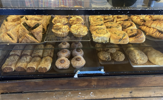 Picture of savoury bakery goods from Mister Nice Guy's bakeshop, with sausage rolls, spinach squares and other savoury vegan goods