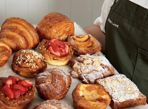 Picture of a man holding a tray of bakery items from Cobb Lane Bakery at South Melbourne Market