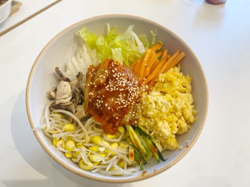 Picture of a Paik Bibim vegan bibimbap bowl with vegetables and rice