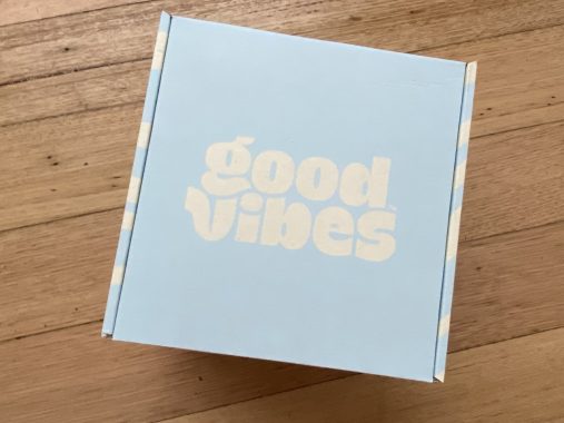 Picture of a cardboard box with 'Good Vibes' on the top, with vegan ice cream inside