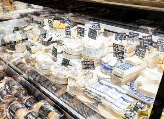 Picture of a cheese cabinet with soft and hard cheese from Pickadeli, which is a stall at South Melbourne Market