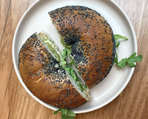 Brightside Bagels menu item, a poppyseed bagel with rocket and spread 