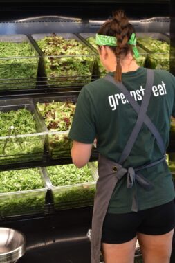 Picture of a Greenstreat Melbourne employee making a Greenstreat salad