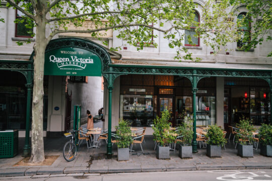 Picture of Queen Victoria Market entrance with shop fronts and bikes visible, which is a reported haunted place in Melbourne