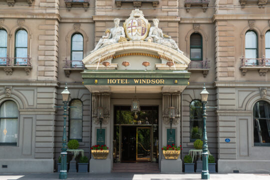 Picture of the Hotel Windsor frontage with the grand entrance in ivory and green colour.