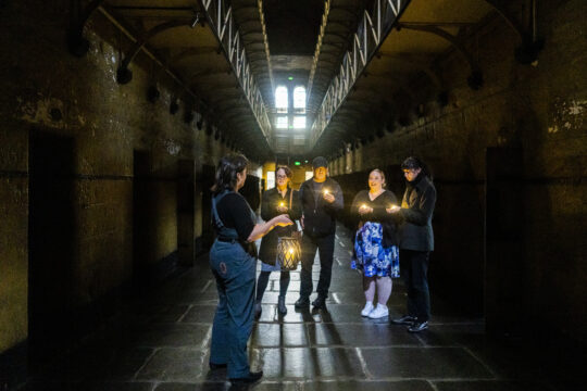 Picture of the Old Melbourne Gaol where tourists are walking as part of a Melbourne ghost tour.