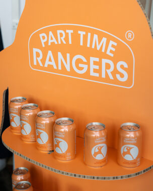 Picture of a peach-coloured cardboard shelf with Part Time Rangers seltzer sitting on a shelf