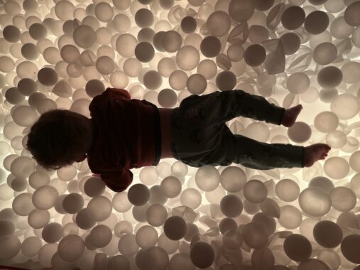 The picture shows the ball pit at Chaos Lab Melbourne with the ground changing colours and turning the balls different colours.