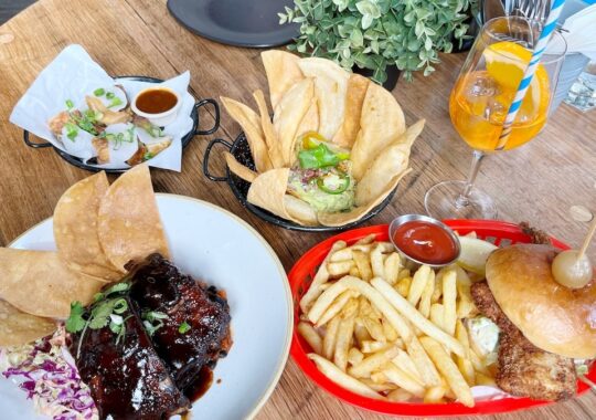 Picture of a spread of The Boatbuilders Yard menu on a wooden table