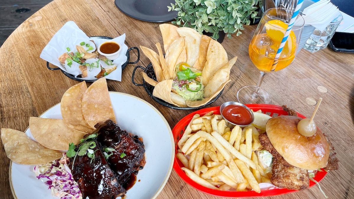 Picture of a spread of The Boatbuilders Yard menu on a wooden table