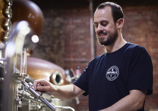 Picture of the head distiller at Republic of Fremantle working on the tools
