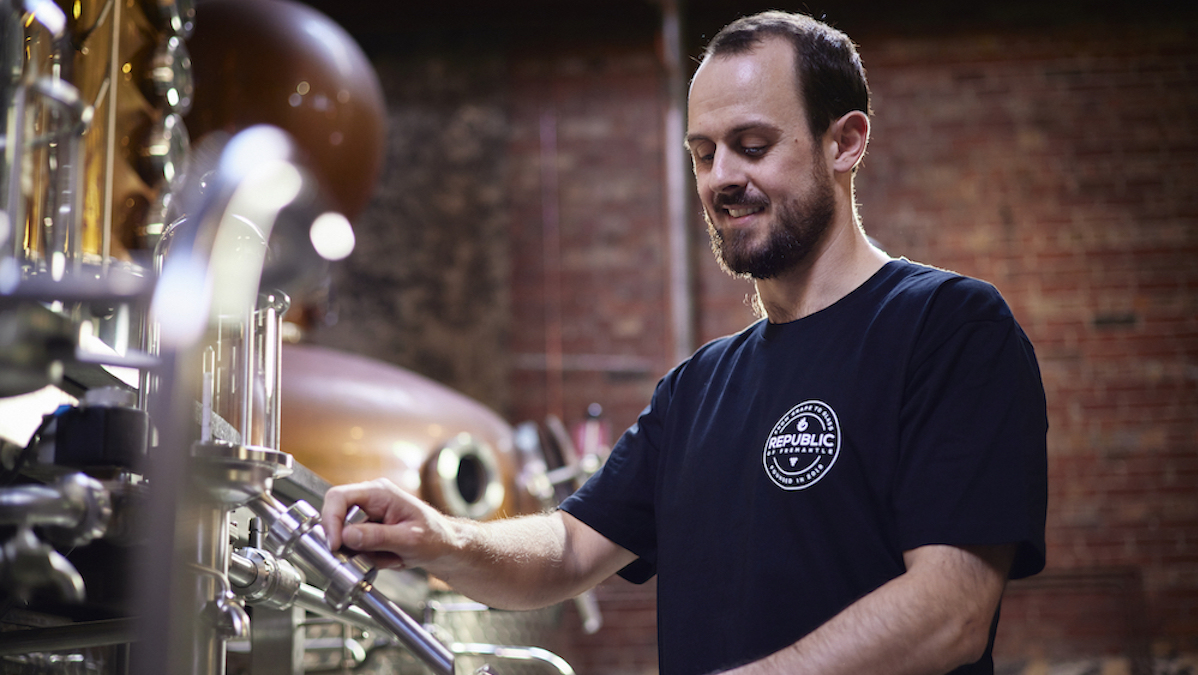 Picture of the head distiller at Republic of Fremantle working on the tools