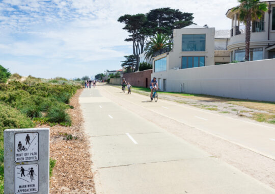 Picture of a group on family friendly bike trails in Melbourne, on the road with the sun in the sky