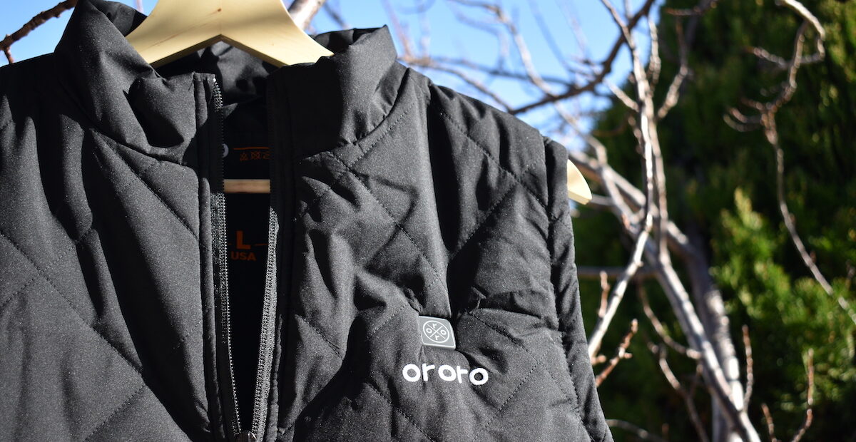 ORORO heated apparel vest hanging in a tree in the sunlight