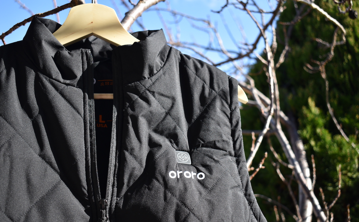 ORORO heated apparel vest hanging in a tree in the sunlight