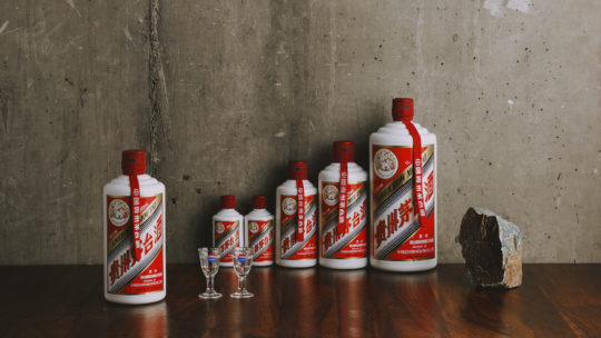 Kweichow Moutai alcohol pictured on a wooden table with a concrete background