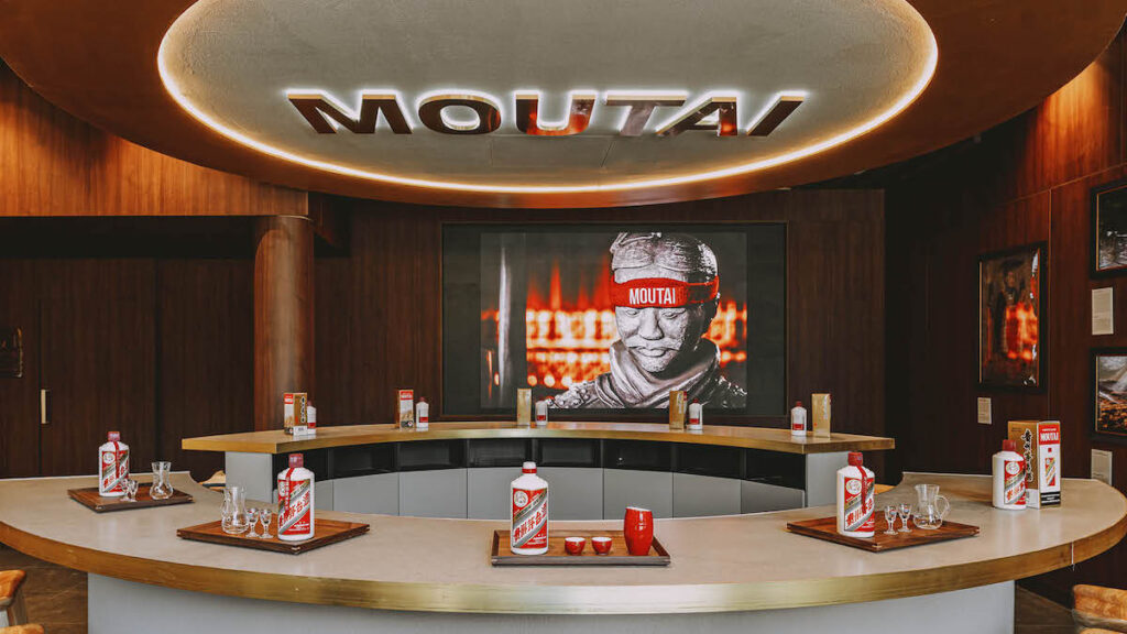 Kweichow Moutai Melbourne store with eight table places and Kweichow Moutai infront of each seat and branding on the wall of the store