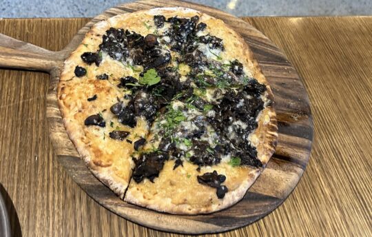 Innocent Bystander Healesville mushroom pizza on a wooden board