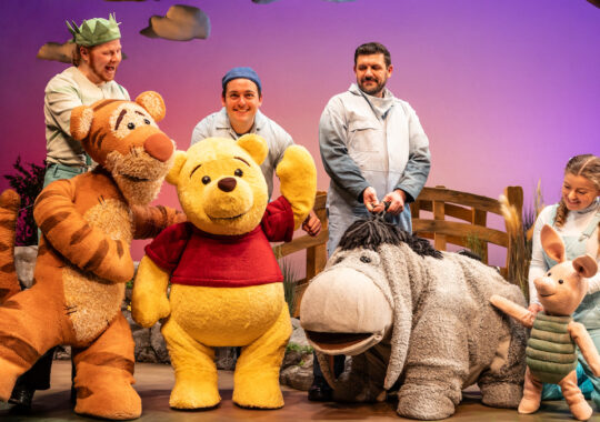 Winnie the Pooh, Tigger, Eeyore and Piglet are standing as life size puppets