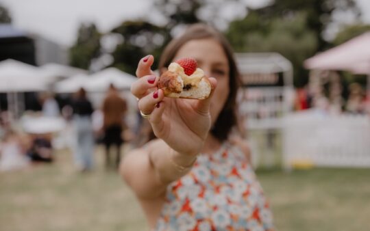 Woman eating a French patisserie at the So Frenchy, So Chic Melbourne festival at Werribee Mansion