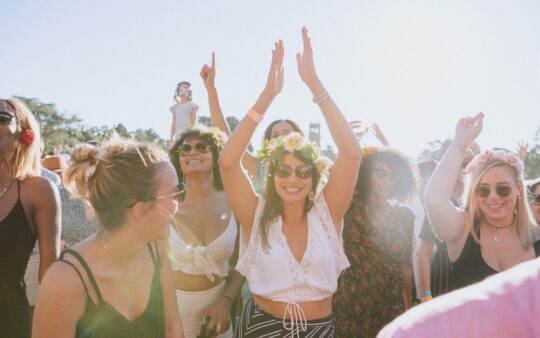 Women dancing next to the main stage at the So Frenchy, So Chic festival at Werribee Mansion in Melbourne