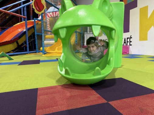 Picture of a child playing in a dinosaur toy at a play centre in Melbourne