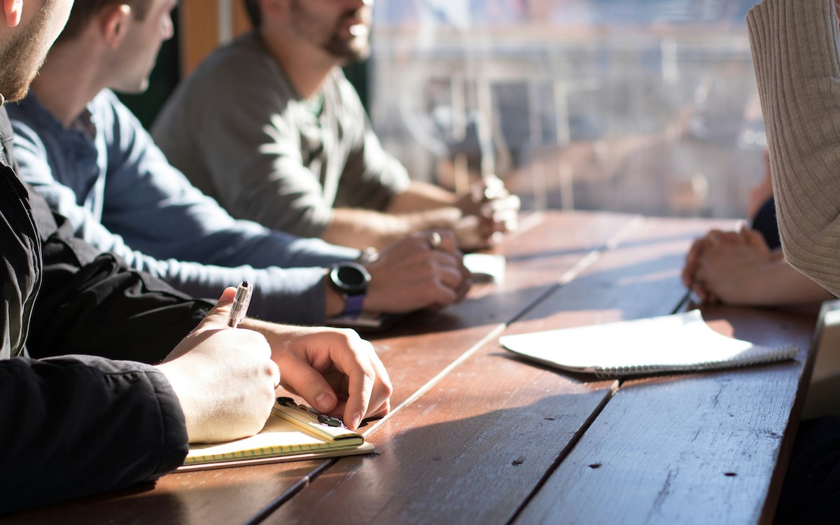 Picture of a team collaborating around a table