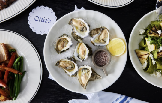 Plate of oysters and dishes of food at Ottie's restaurant at Crowne Plaza Restaurant in Southbank