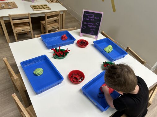 Child playing at an activity table at Eden Play Mill Park