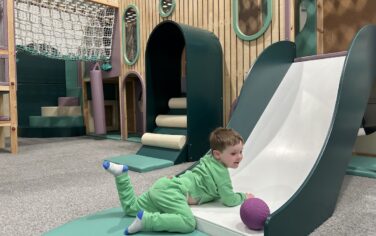 Picture of a child going down a slide at Eden Play Mill Park play centre in Melbourne