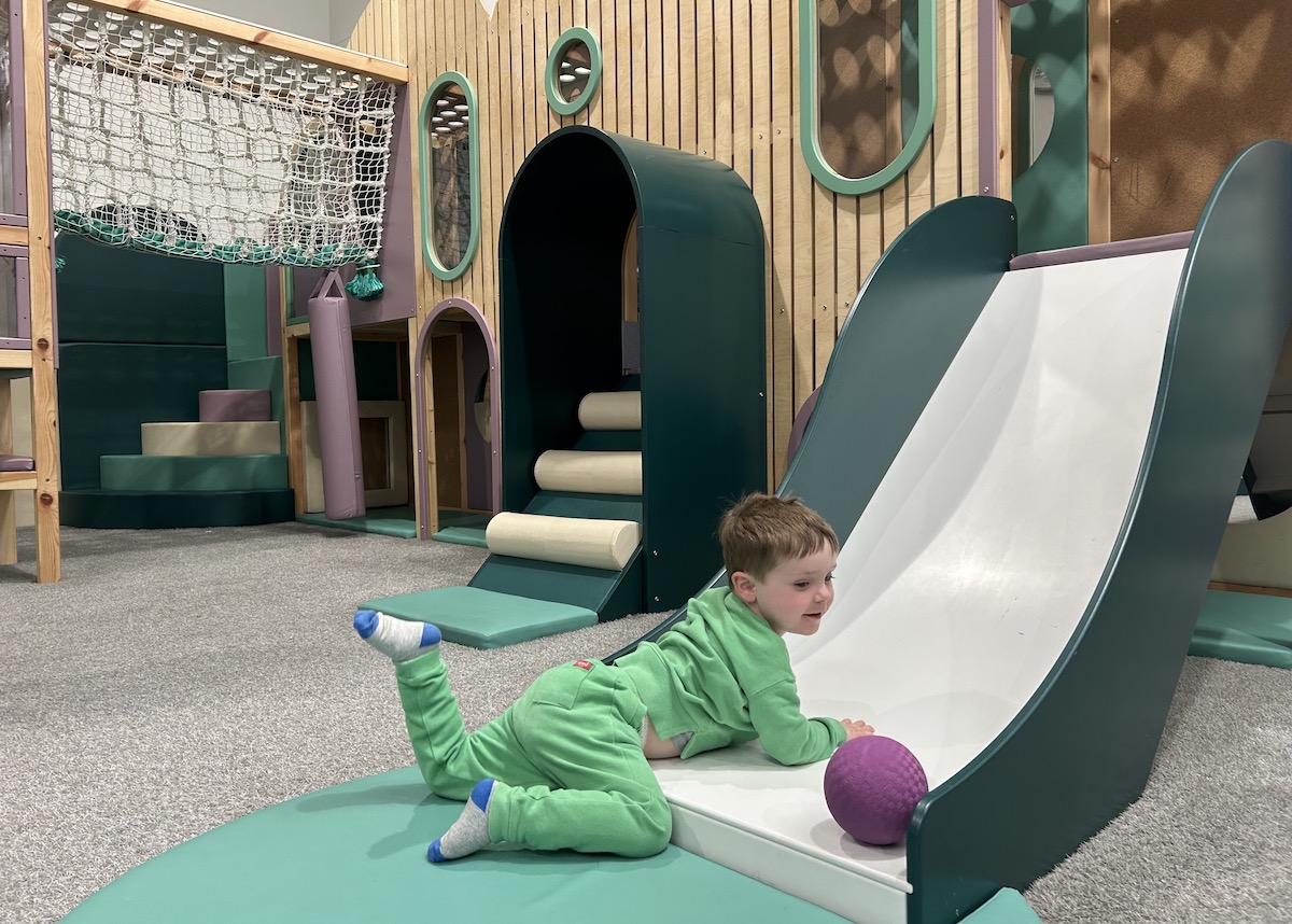 Picture of a child going down a slide at Eden Play Mill Park play centre in Melbourne